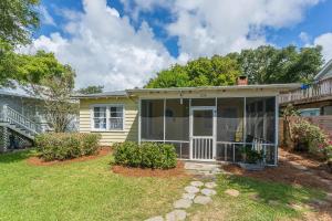 a small yellow house with a porch at Waterside - 829 Park Way in Saint Simons