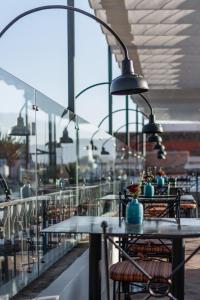 a restaurant with tables and chairs on a balcony at Casa 1810 Hotel Boutique in San Miguel de Allende