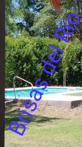 a group of blue signs in front of a pool at BRISAS DEL RIO in Santiago del Estero