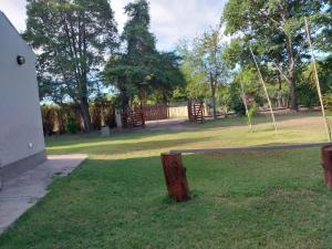 a park with a fence and a swing at BRISAS DEL RIO in Santiago del Estero