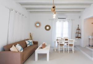 a living room with a couch and a table at Amma Houses Sea View in Kalafatis