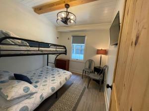 a bedroom with a bunk bed and a desk at Tree Spirit Retreat - 4310 Third Street in Saint Simons Island