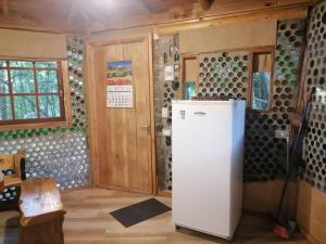 a kitchen with a refrigerator in a room at Cabaña Amor de los Tronquitos, Camino Villarrica in Villarrica