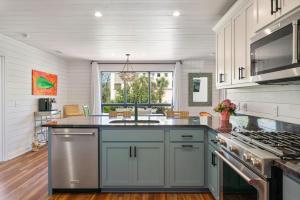 a kitchen with white walls and a blue counter top at Three Oaks Beach Cottage - 2215 Bruce Drive in Saint Simons Island