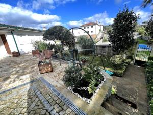 a garden with a bench and a bunch of plants at Villa Henriques in Ponte de Lima