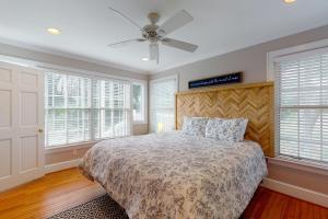 a bedroom with a bed and a ceiling fan at 44 Dune House - 1901 Dixon Lane in Saint Simons Island +22 photos
