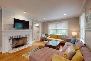 a living room with a couch and a fireplace at 44 Dune House - 1901 Dixon Lane in Saint Simons Island