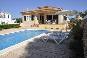 a villa with a swimming pool and a house at Villa Francisca in Sa Caleta