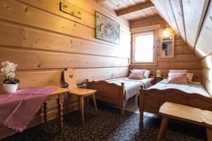 a room with two beds and a table in a cabin at Zakopane - Harenda 13e in Zakopane