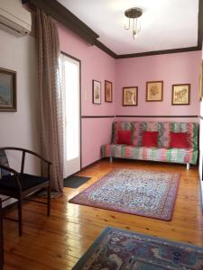 a living room with a couch and a window at Cosy Penthouse -up to 6 guests- in the City Centre! in Thessaloniki