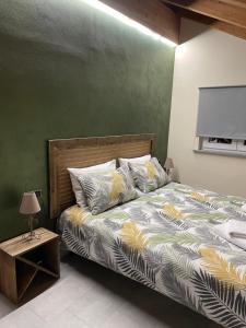 a bedroom with a bed with a green wall at B&B La DORMERIA in Finale Ligure
