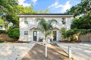 ein weißes Haus mit einer Palme davor in der Unterkunft Sunny Dayz - 4 bedrooms 1122 & 1124 Park in Demere Park