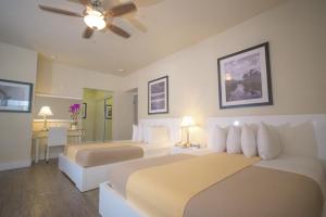 a hotel room with two beds and a ceiling fan at Ocean Five Hotel in Miami Beach