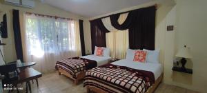 Cette chambre comprend 2 lits et une fenêtre. dans l'établissement Casa Hadassa La Cañada, à Palenque