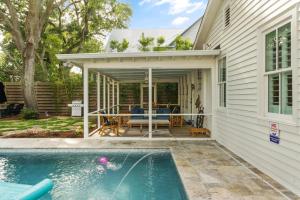 a house with a swimming pool and a patio at Endless Summer - 4217 - 6th Street in Saint Simons Island