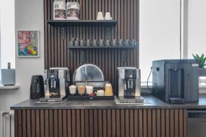 a counter with two coffee machines on it at Bank Guesthouse by KEF Airport in Keflavík