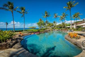 a pool at a resort with palm trees at Wailea Beach Villas by Coldwell Banker Island Vacations in Wailea