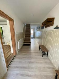 a hallway with a staircase and a wooden table at Ferienhaus Harzcolor Wernigerode in Wernigerode