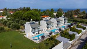 an aerial view of a house with a swimming pool at White Pearl in Pefkochori