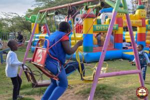a woman and a child playing on a playground at ROYAL ACACIA HOTEL ISIOLO in Tarbaj