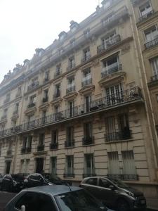 a large building with cars parked in front of it at Studio pied du métro Neuilly Paris La Défense pour 3 maxi in Neuilly-sur-Seine
