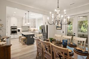 a kitchen and dining room with a table and chairs at Viewpoint Oaks - 301 7th Street, Unit 101 in Saint Simons