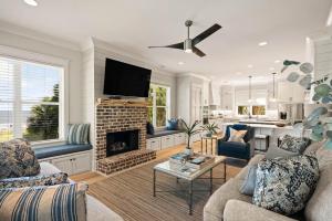a living room with a couch and a fireplace at Viewpoint Oaks - 301 7th Street, Unit 101 in Saint Simons