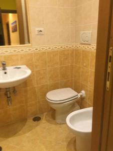 a bathroom with a toilet and a sink at Rose Village Guest House in Rome