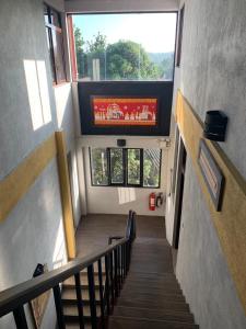 a staircase in a building with a large window at Blue Pillars Kandy in Kandy