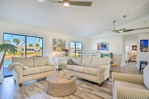 a living room with two couches and a table at Beachy Cape Coral Home - Swim, Fish, Boat! in Cape Coral