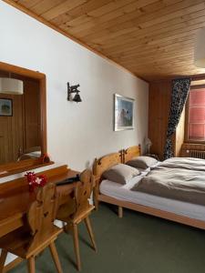 una camera con 2 letti singoli e una scrivania di Auberge de l'Ange ad Albeuve