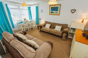 a living room with two couches and a table at CROYDE SEA BREEZE 3 Bedrooms in Croyde