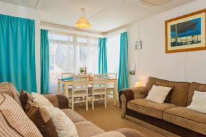 a living room with a couch and a table at CROYDE SEA BREEZE 3 Bedrooms in Croyde