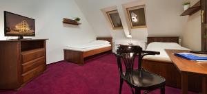 a hotel room with a desk and a bed and a desk at Brioni Boutique Hotel 4* in Ostrava
