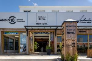 a store front of a building with wooden doors at Nobile Hotel Montoya in Punta del Este