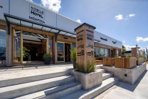 a building with steps in front of a store at Nobile Hotel Montoya in Punta del Este