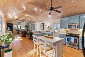 a kitchen with blue cabinets and a ceiling fan at Live Oak Retreat - 2104 Bruce Drive in Saint Simons Island