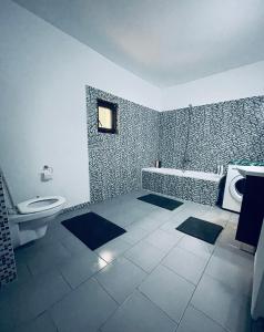 a bathroom with a toilet and a tub and a sink at Casa POTE in Covasna +30 photos