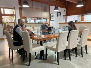 a group of people sitting around a table with laptops at Villa Alba Boutique Hotel in Pescara