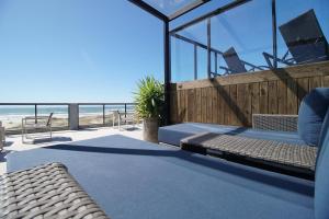 a house with a balcony with a view of the beach at Aruá Pousada Boutique in Torres