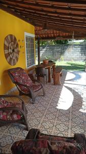 a patio with chairs and a table in a room at Casa temporada na praia Joia do Atlântico - Ilhéus - Ba in Ilhéus