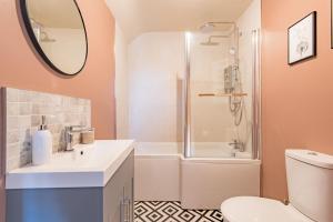 a bathroom with a shower and a toilet and a sink at Whitstable Hideaway by Bloom Stays in Whitstable