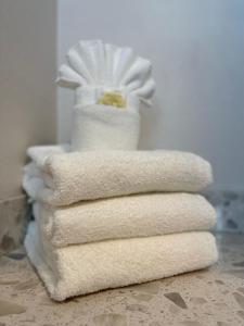 a stack of white towels sitting on top of a table at The Historic Brookdale Lodge, Santa Cruz Mountains in Brookdale