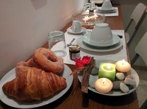 a table with a plate of pastries and candles at Bed & Breakfast Al Ponte in Scanno