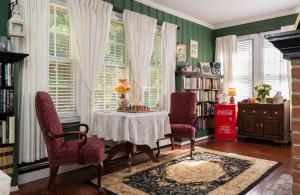 a dining room with a table and two chairs at A Williamsburg White House Inn in Williamsburg