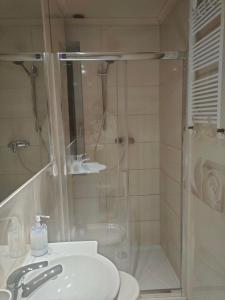 a bathroom with a shower and a toilet and a sink at Marlove Apartment Wrocław in Wrocław