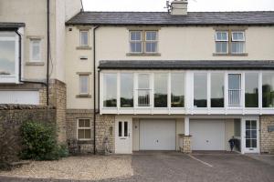 a large house with glass windows and a driveway at River View in Ingleton
