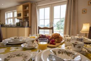 a dining room table with a plate of food on it at River View in Ingleton