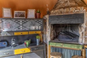 a kitchen with an old oven in a room at Mini kamp Perla in Prvić Luka