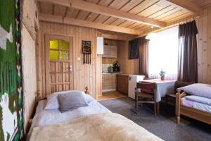 a bedroom with a bed and a kitchen with a table at Zakopane - Króle 16 in Zakopane